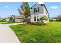 Two-story house with gray exterior and a dark garage door at 1911 Fan Aloe Way, Ruskin, FL 33570