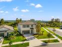 Two-story house with gray exterior, situated on a corner lot at 1911 Fan Aloe Way, Ruskin, FL 33570