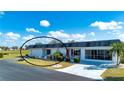 Single story home with a carport and landscaped yard at 332 Club Manor Dr # 10, Sun City Center, FL 33573