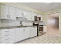 Kitchen features white cabinets, granite countertops, and stainless steel appliances at 11200 102Nd Ave # 136, Seminole, FL 33778