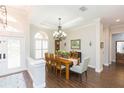 Elegant dining room with hardwood floors, chandelier, and view to entry at 15802 Sorawater Dr, Lithia, FL 33547