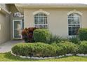 Home exterior showcasing well-maintained landscaping at 2700 Hawk Roost Ct, Holiday, FL 34691