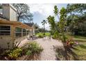 Brick paved patio with seating area and lush landscaping at 3006 Bolt Dr, Palm Harbor, FL 34685