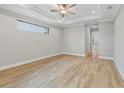 Large main bedroom with light hardwood floors and ceiling fan at 4047 Southern Valley Loop, Brooksville, FL 34601