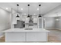 Modern kitchen with white cabinets, quartz countertops, and island at 4047 Southern Valley Loop, Brooksville, FL 34601