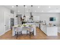 Modern kitchen with white cabinetry, large island, and stainless steel appliances at 4187 Southern Valley Loop, Brooksville, FL 34601