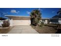 Single-story home with attached garage and landscaping at 8525 42Nd N Ave, St Petersburg, FL 33709