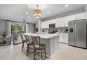 Bright kitchen featuring white cabinets and a large island at 8607 Canyon Creek Trl, Parrish, FL 34219