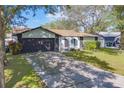 Home with a long driveway and a two-car garage at 140 Meadowlark Dr, Safety Harbor, FL 34695