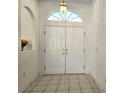 Bright entryway with double doors and tile flooring at 17820 Monteverde Dr, Spring Hill, FL 34610