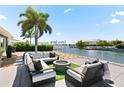 Expansive patio with firepit, seating area, and waterfront views at 2599 W Bay Isle Se Dr, St Petersburg, FL 33705