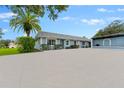Charming single-story home featuring a large driveway, and mature landscaping including a palm tree at 3361 Scorecard Dr # 0, New Port Richey, FL 34655