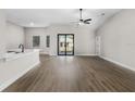 Bright and airy living room featuring wood-look floors, high ceilings, and access to the backyard at 4570 Gillot Blvd, Port Charlotte, FL 33981