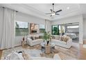Bright living room with large windows and sliding glass doors leading to a patio at 6157 Dusk Rose Ln, Brooksville, FL 34601