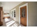 Front porch with tiled floor and wooden door at 1045 17Th N Ave, St Petersburg, FL 33704