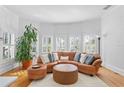 Bright living room with curved seating and large windows at 1718 1St N St, St Petersburg, FL 33704