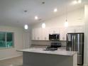 Modern kitchen with island and stainless steel appliances at 2452 Nantucket Ter, North Port, FL 34286