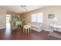 Bright living room with hardwood floors, comfy seating, and access to a balcony at 315 30Th W Ave # B201, Bradenton, FL 34205