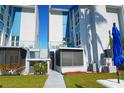 The exterior of a beautiful condo shows the screened in lanai and second floor balcony at 179 Medallion Blvd # C, Madeira Beach, FL 33708