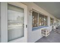 White door with window and ac unit on brick wall at 2353 Shelley St # 4, Clearwater, FL 33765