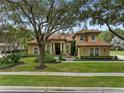Two-story house with tile roof and landscaping at 531 Isleworth Close, Tarpon Springs, FL 34688