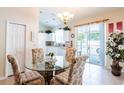 Cozy kitchen features a glass-top table and chairs, white cabinets and easy access to the backyard at 24617 Laurel Ridge Dr, Lutz, FL 33559