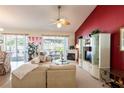 Bright living room with vaulted ceilings, a fireplace, and access to the patio at 24617 Laurel Ridge Dr, Lutz, FL 33559