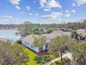 Aerial view of a house with lake access and lush surroundings at 25316 Flying Ebony Ln, Wesley Chapel, FL 33544