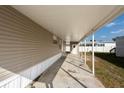 Covered patio area with access to a storage unit at 38029 Leondias Dr, Zephyrhills, FL 33542