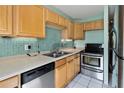 Kitchen with wood cabinets and stainless steel appliances at 131 114Th Ne Ter # 131, St Petersburg, FL 33716