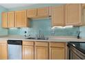 Kitchen with wood cabinets and stainless steel appliances at 131 114Th Ne Ter # 131, St Petersburg, FL 33716