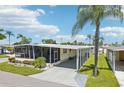 This charming single-wide home features a covered carport and landscaped yard at 18675 Us Highway 19 N # 488, Clearwater, FL 33764