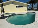 Backyard pool offers a relaxing retreat, complemented by a jacuzzi and clean white tiling at 239 Punta Vista Dr, St Pete Beach, FL 33706