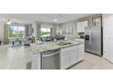 Modern kitchen with island, stainless steel appliances, and granite countertops at 32768 Osprey Peak Way, San Antonio, FL 33576