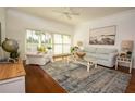 Bright and airy living room with hardwood floors and coastal decor at 4630 Mirabella Ct, St Pete Beach, FL 33706