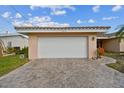 White garage door and brick driveway at 529 Johns Pass Ave, Madeira Beach, FL 33708