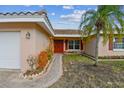 House exterior with a red door and walkway at 529 Johns Pass Ave, Madeira Beach, FL 33708