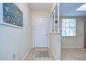 Bright entryway with tiled floor and a view into the kitchen at 6712 Holly Ct, Zephyrhills, FL 33542