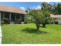 Neat front yard with lush green grass at 8101 Casuarina Dr, Port Richey, FL 34668