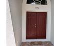 Double front door with address number 27542 above it and a decorative welcome mat at 27542 Sky Lake Circle, Wesley Chapel, FL 33544