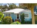 Light blue house with a metal roof, and nicely landscaped yard at 4302 W Obispo St, Tampa, FL 33629