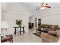 Bright living room with tile floors, neutral paint, ceiling fan, and view to dining area at 460 48Th S St, St Petersburg, FL 33711
