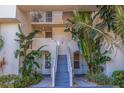 Building exterior with stairs and tropical landscaping at 5281 Isla Key S Blvd # 206, St Petersburg, FL 33715