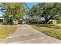 Charming single-story home featuring an attached garage and a long driveway at 5303 W Cleveland St, Tampa, FL 33609