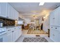White kitchen cabinets, granite countertops, and modern appliances at 5330 Vera St, Zephyrhills, FL 33542
