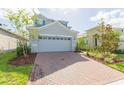 Two-story house with gray siding and brick driveway at 5625 Del Coronado Dr, Apollo Beach, FL 33572