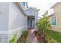 Inviting front entry with a blue door and brick walkway at 5625 Del Coronado Dr, Apollo Beach, FL 33572
