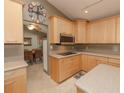 Bright kitchen with light wood cabinets, stainless steel appliances, and an island at 8900 143Rd St, Seminole, FL 33776