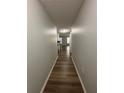 Long hallway with light walls and wood-look flooring at 2690 Coral Landings Blvd # 535, Palm Harbor, FL 34684
