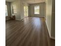 Bright living room with new flooring and sliding glass doors leading to a balcony at 2690 Coral Landings Blvd # 535, Palm Harbor, FL 34684